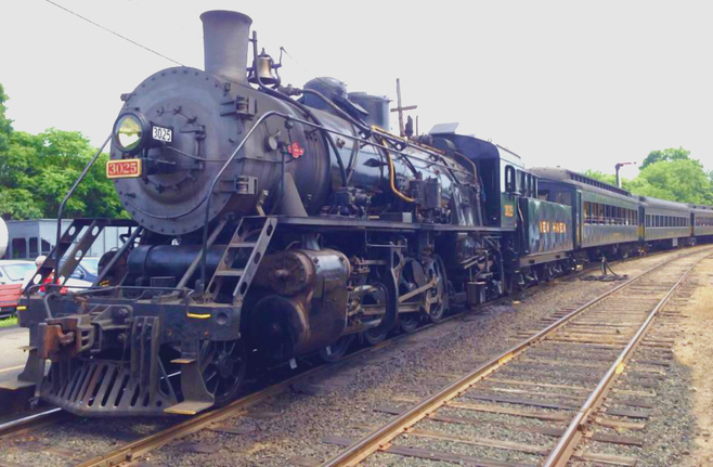 Steam locomotive with passenger train. 