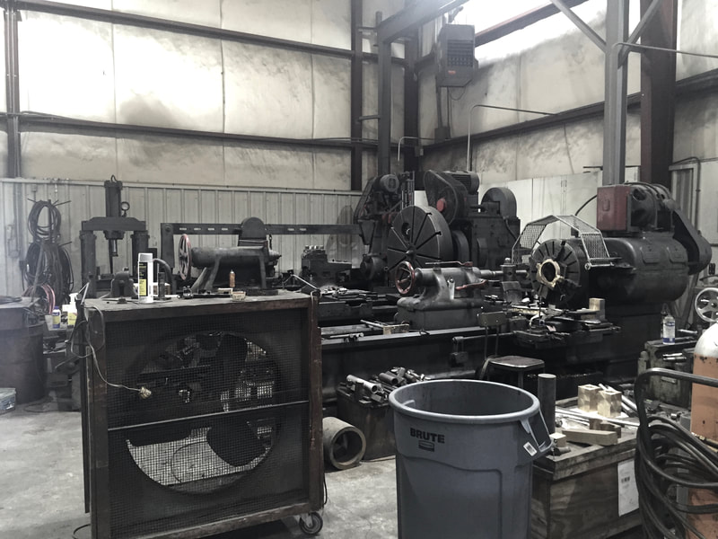 Interior of steam locomotive repair shop. Lathes and machinery. 